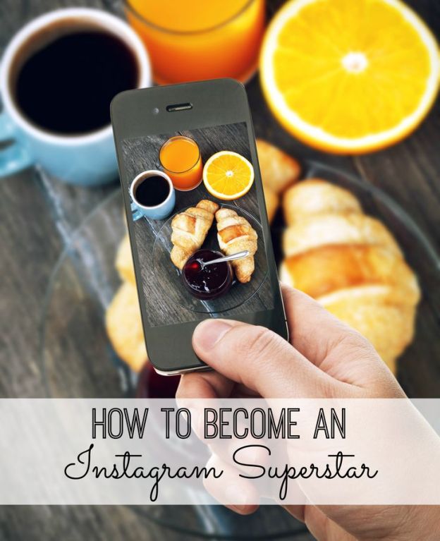 Hand with smartphone taking food photo of fresh breakfast with coffee and croissants