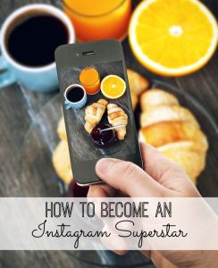 Hand with smartphone taking food photo of fresh breakfast with coffee and croissants